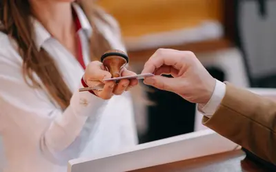a woman holding a pair of scissors in her hands at Hotel Leon D´Oro in Prague