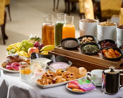 a table topped with different types of food and drinks at Hotel Leon D´Oro in Prague