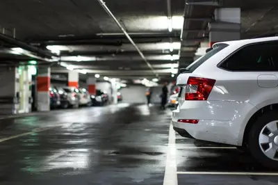 a white car parked in a parking garage at Hotel Leon D´Oro in Prague