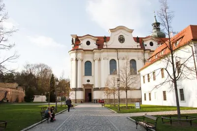 a large white building with a clock tower on it at Hotel Adalbert in Prague