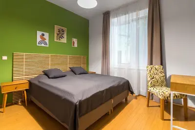a bedroom with a bed and a desk and a window at Hotel Museum in Prague