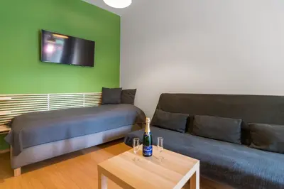 a living room with a couch and a bed at Hotel Museum in Prague