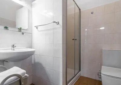 a bathroom with a shower and a sink at Hotel Museum in Prague