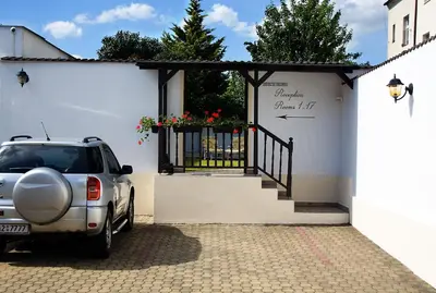 a car parked in front of a building with a gate at Hotel Excellent in Prague