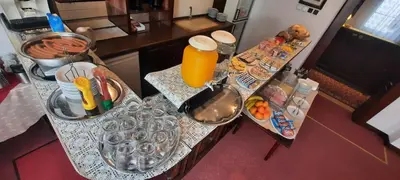 an aerial view of a kitchen counter with food and orange juice at Hotel Excellent in Prague