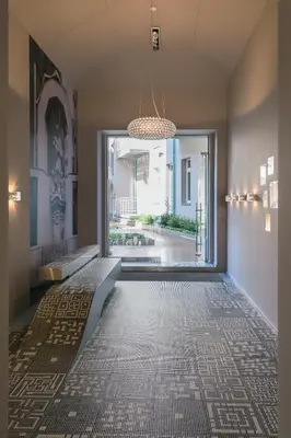 a hallway with a tile floor and a large window at Stay in heart of town in Prague