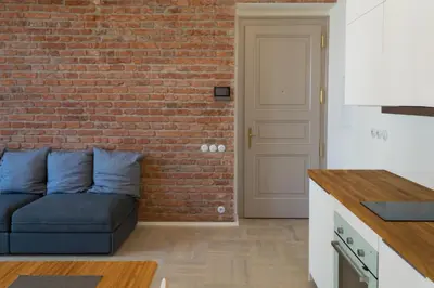 a living room with a brick wall and a couch at Stay in heart of town in Prague