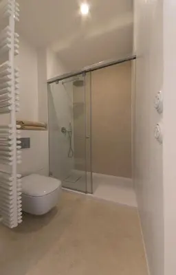 a bathroom with a glass shower with a toilet at Stay in heart of town in Prague