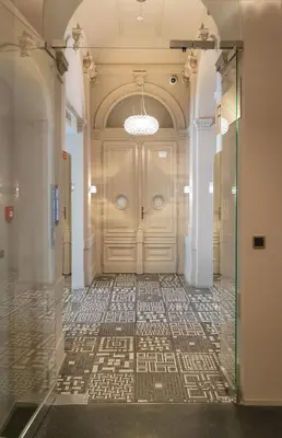 a hallway with a door and a tile floor at Stay in heart of town in Prague