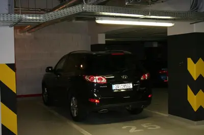 a small black car parked in a parking garage at Karlín Apartment in Prague