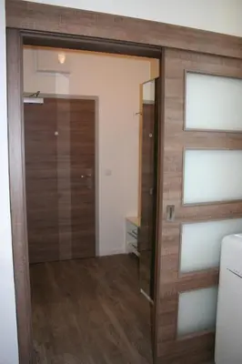 a sliding glass door in a room with wood at Karlín Apartment in Prague