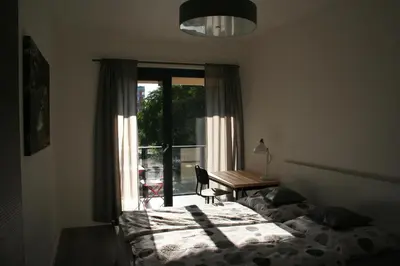 a bedroom with a bed and a window and a desk at Karlín Apartment in Prague
