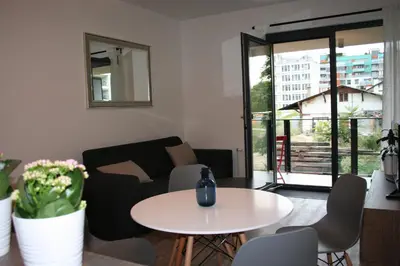 a living room with a table and a couch at Karlín Apartment in Prague