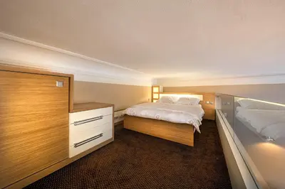 a small bedroom with two beds and a dresser at Stylish apartment in old town Prague in Prague