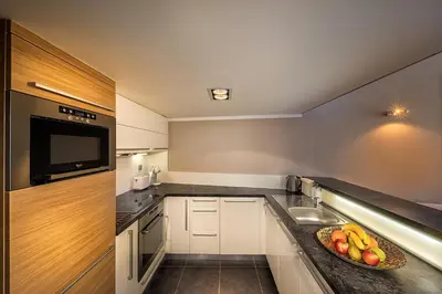 a small kitchen with a bowl of fruit on a counter at Stylish apartment in old town Prague in Prague