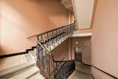 a staircase in a home with a wrought iron railing at Stylish apartment in old town Prague in Prague