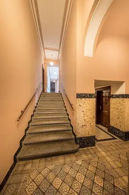 a staircase in an old building with a tile floor at Stylish apartment in old town Prague in Prague