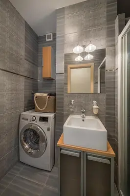 a bathroom with a sink and a washing machine at Stylish apartment in old town Prague in Prague