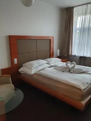 a bedroom with a bed with two swans on it at Hotel Jerabek in Prague