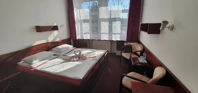 a hospital room with a bed and two chairs at Hotel Jerabek in Prague