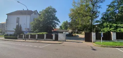 a white building with a fence next to a street at Hotel Jerabek in Prague