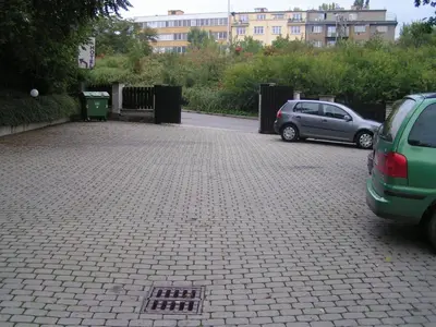 a parking lot with two cars parked next to a building at Hotel Jerabek in Prague