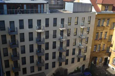 an apartment building with balconies and fire escapes at Aparthotel Austria Suites in Prague