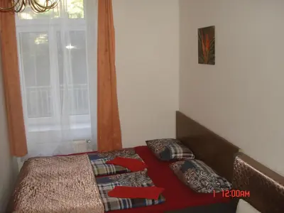 a bedroom with a bed with pillows and a window at Pension Easy Journey in Prague