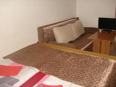 a living room with a couch and a mirror at Pension Easy Journey in Prague
