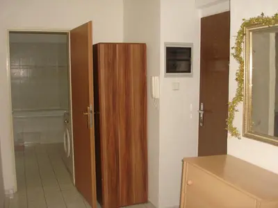 a bathroom with a wooden cabinet next to a toilet at Pension Easy Journey in Prague