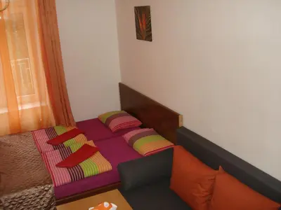 a bed with colorful pillows on it in a room at Pension Easy Journey in Prague