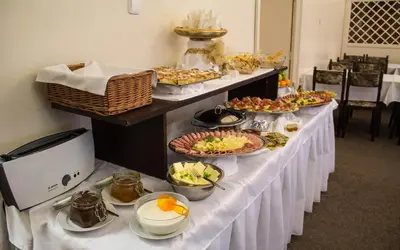 a buffet line with many plates of food on it at Anette Hotel in Prague