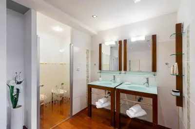 a bedroom with two beds and a window at Apartments Almandine in Prague