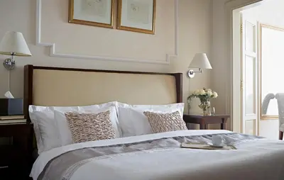 a bedroom with a bed with white sheets and pillows at Apartments Almandine in Prague