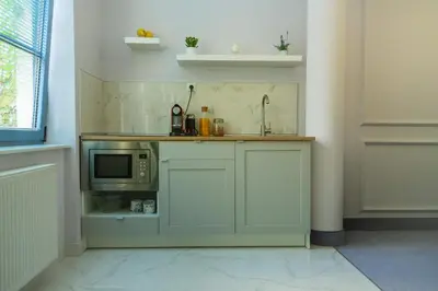 a kitchen with a counter with a microwave at Apartments Almandine in Prague