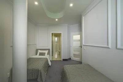 a bedroom with two beds and a mirror at Apartments Almandine in Prague