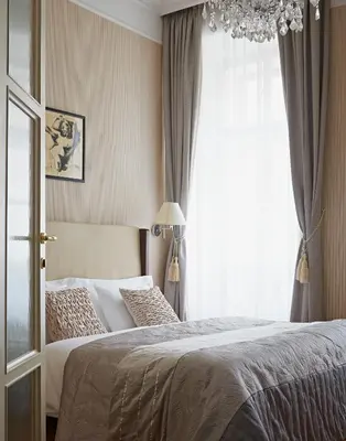 a bedroom with a bed and a table with a chair at Apartments Almandine in Prague