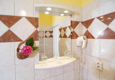 a bathroom with a sink and a mirror at Pension Dientzenhofer in Prague