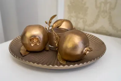 two gold pears on a plate on a table at Studio near Congress Centre II. in Prague
