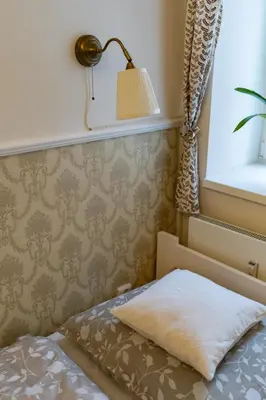a bedroom with a bed with a lamp and a window at Studio near Congress Centre II. in Prague