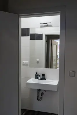 a bathroom with a white sink and a mirror at Studio near Congress Centre II. in Prague
