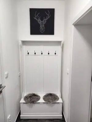 a white closet with two furry pillows on a shelf at Studio near Congress Centre II. in Prague