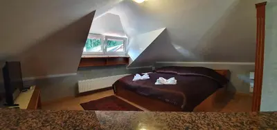 a bedroom with a bed with white towels on it at Hotel Karlštejn & SPA in Karlštejn