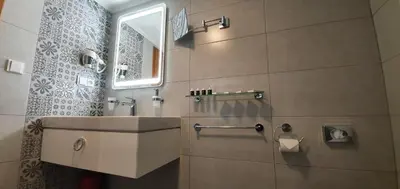 a bathroom with a sink and a mirror at Hotel Karlštejn & SPA in Karlštejn
