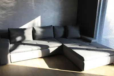 a couch sitting in a room with a window at Blue House Relax in Velké Popovice