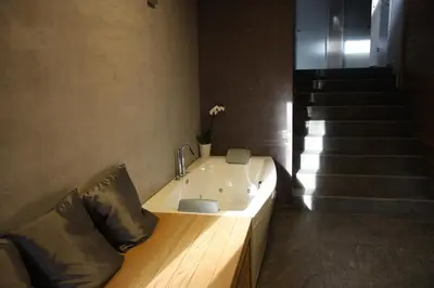 a bathroom with a sink and a staircase at Blue House Relax in Velké Popovice