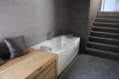 a bathroom with a sink and a staircase at Blue House Relax in Velké Popovice
