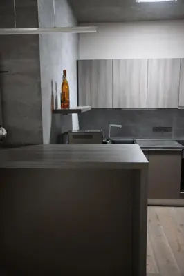 a kitchen with a counter with a bottle on it at Blue House Relax in Velké Popovice