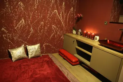 a bathroom with a sink and a red wall at Blue House Relax in Velké Popovice