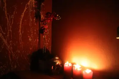 a group of lit candles in a room with a wall at Blue House Relax in Velké Popovice